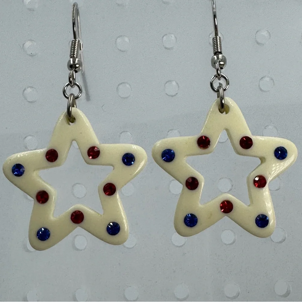 White Plastic Star Earrings With Red and Blue Rhinestones